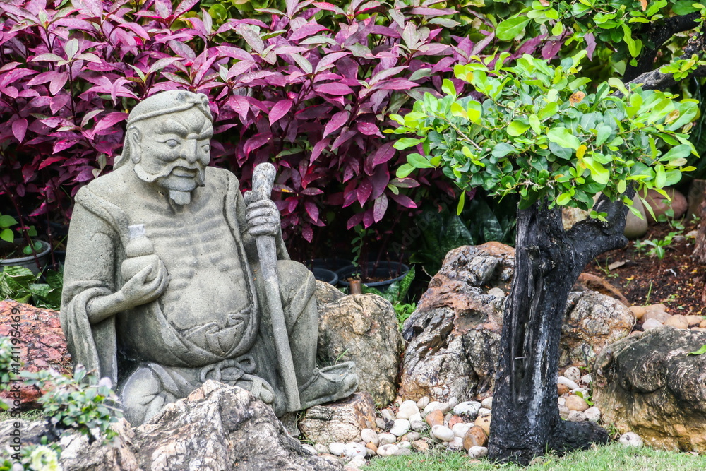 Sculpture of Chinese person, Antique stone carving doll in temple, Bangkok, Thailand.