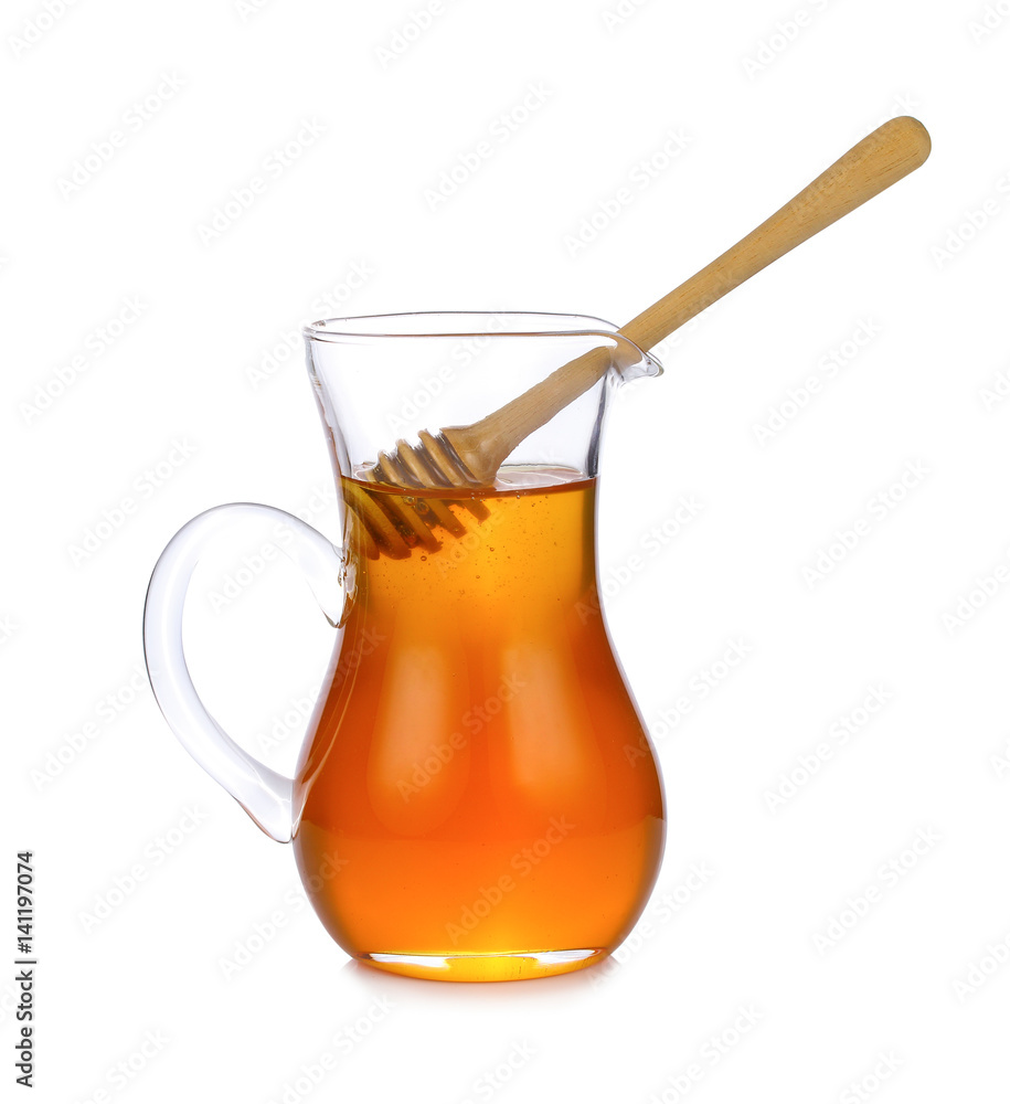 Jar of honey with wooden drizzler isolated on white background Jar of honey with wooden drizzler isolated on white background
