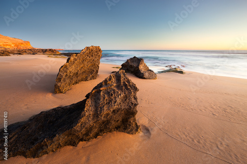 Wall Mural A rocky shoreline sunset