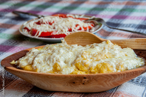 Traditional Montenegrin Meal - Kacamak in wooden bowl