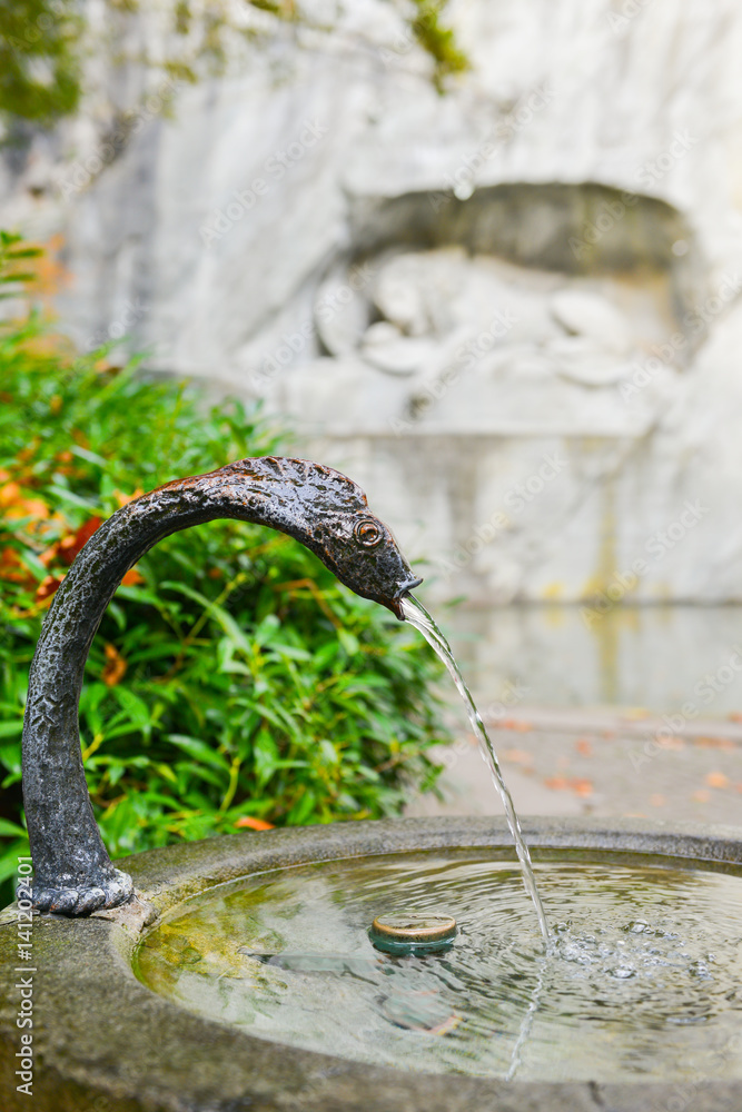 Water fountain near memorial of dying lion in Lucerne, Switzerland Water fountain near memorial of dying lion in Lucerne, Switzerland