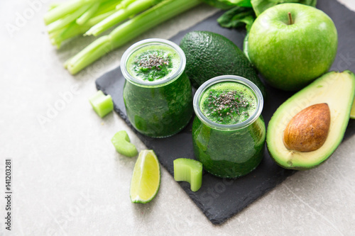 Blended green smoothie with ingredients. Superfood, detox and healthy concept. selective focus