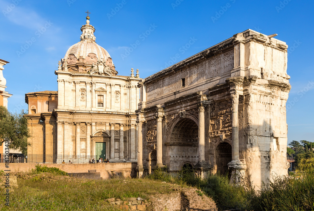 Rome, Italy. The Roman Forum: the arch of Septimius Severus (203) and the church of Santi-Luca-e-Martina