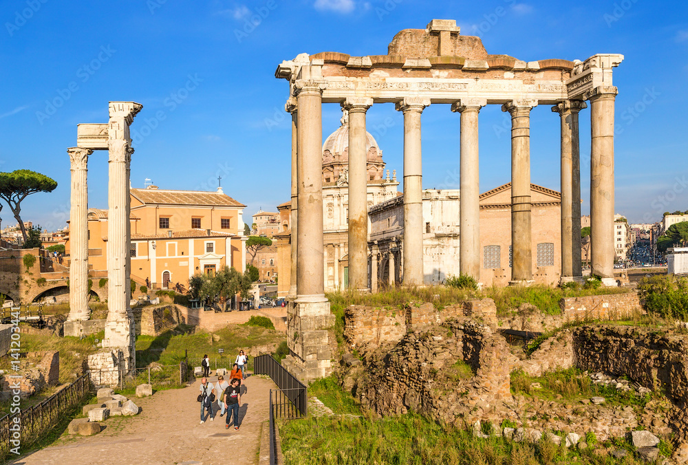 Rome, Italy. The ruins of the Roman Forum: on the left - the temple of Vespasian and Titus (Tempio di Vespasiano e Tito), 79, on the right - the temple of Saturn (489 BC - 283 AD)