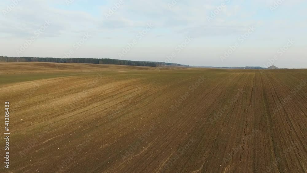 4K. Low flight above freshly cultivated fields in spring, aerial panoramic view. 4K. Low flight above freshly cultivated fields in spring, aerial panoramic view.