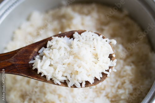 Cooked rice in pot with wood ladle