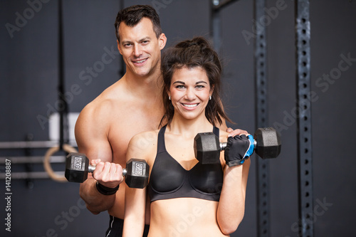 Barbell training man and womanin a gym