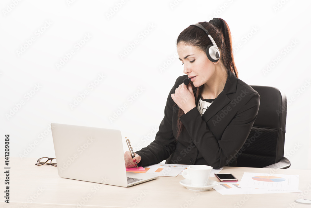 Young secretary with headset answering a call Young secretary with headset answering a call
