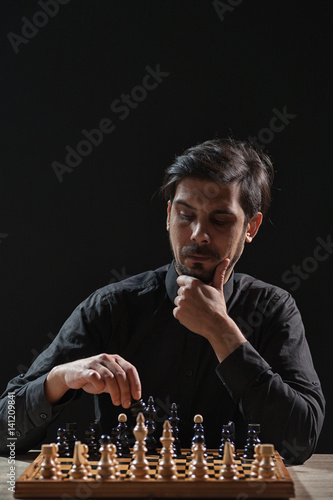 Portrait of adult man who is participating in chess game.