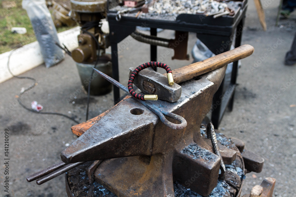 Anvil, bracelet and hammer.