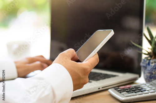 Businessman's hands with Mobile phone.\ photo