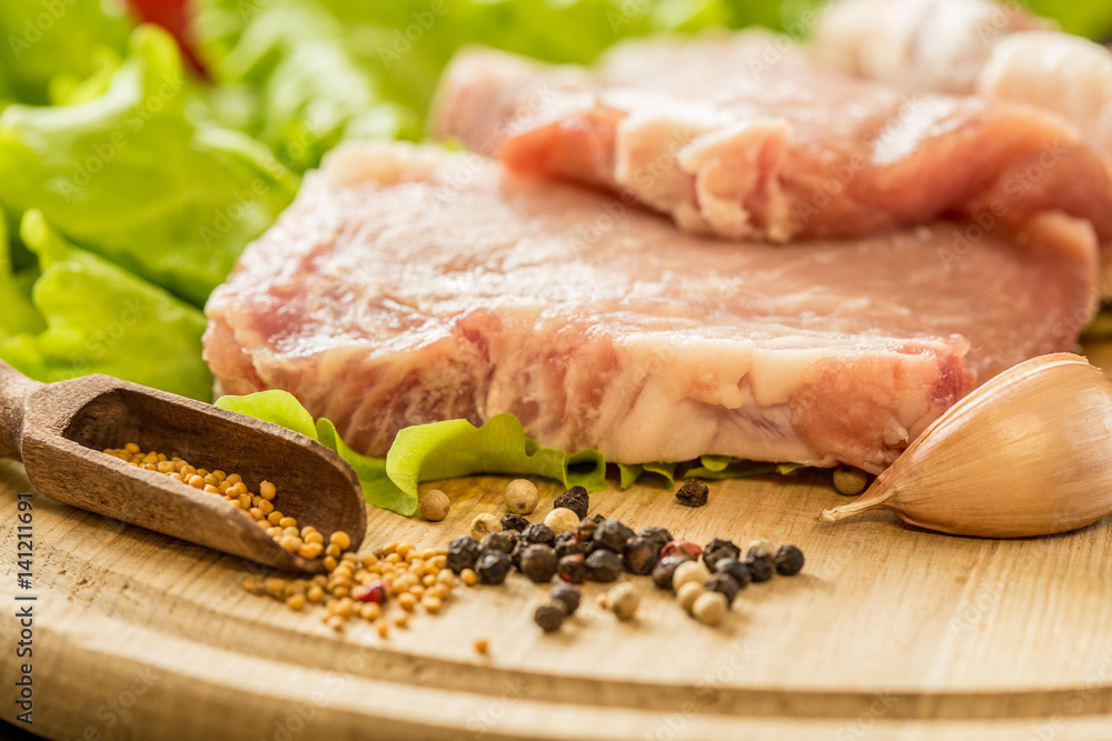 Slices of raw meat. Pork escalope on a wooden board. Slices of raw meat. Pork escalope on a wooden board.