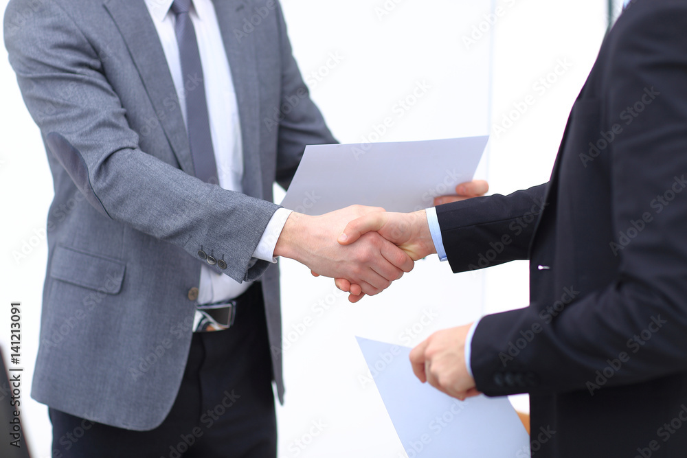 Close up view of business partnership handshake concept.Photo of two businessman handshaking process.Successful deal after great meeting