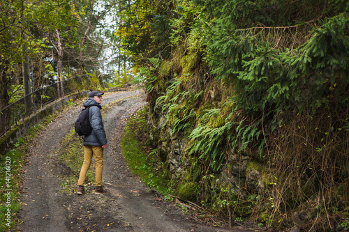 man with a backpack on a forest path.
