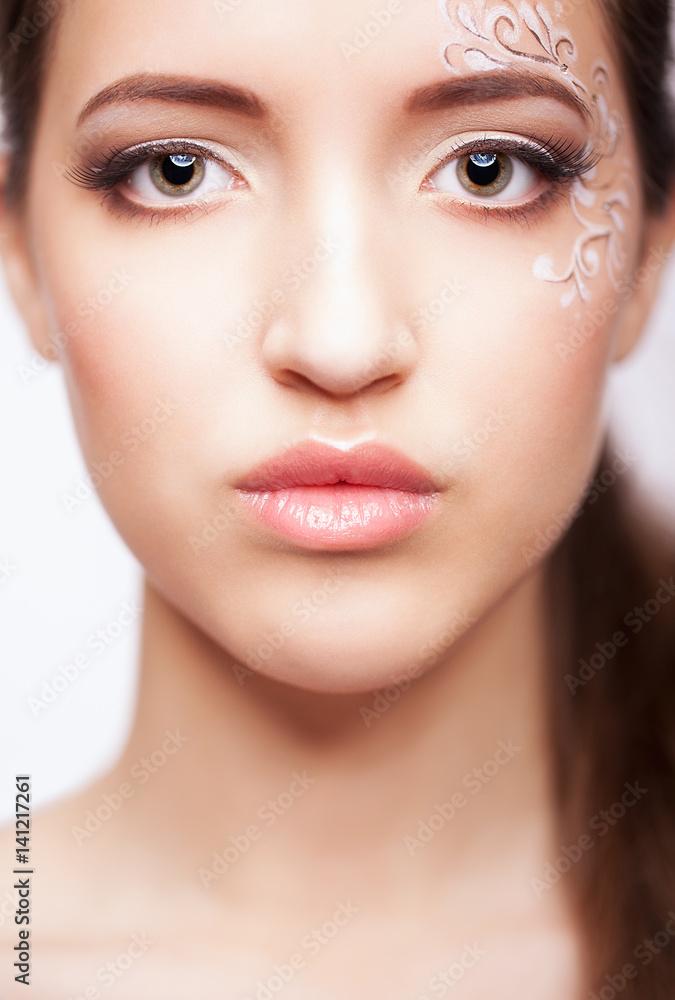 Close-up portrait of young woman with face art make up Close-up portrait of young woman with face art make up