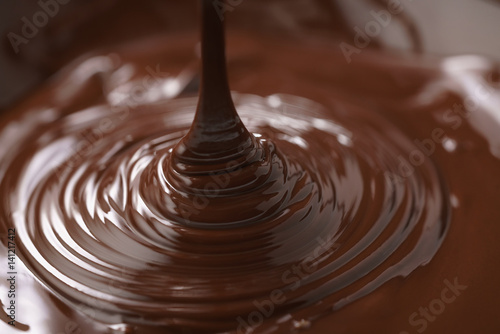 macro photo of premium dark chocolate pour in bowl, shallow focus