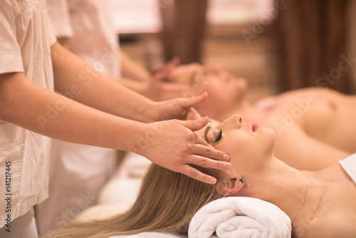 couple enjoying head massage at the spa