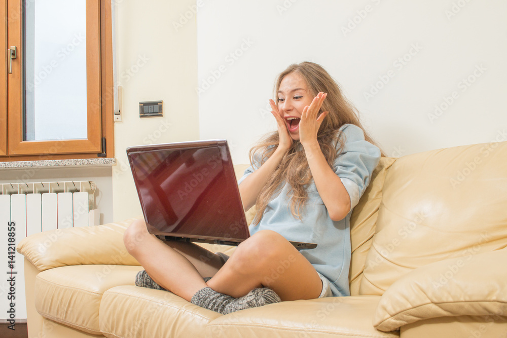 young woman with laptop computer excited with raised hands and surprise expression. young woman with laptop computer excited with raised hands and surprise expression.
