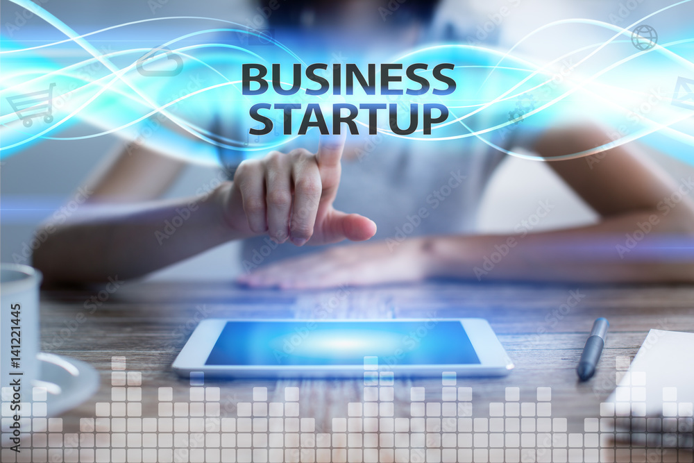 Woman using tablet pc, pressing on virtual screen and selecting business startup.