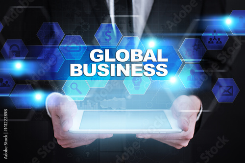 Businessman holding tablet PC with global business concept.