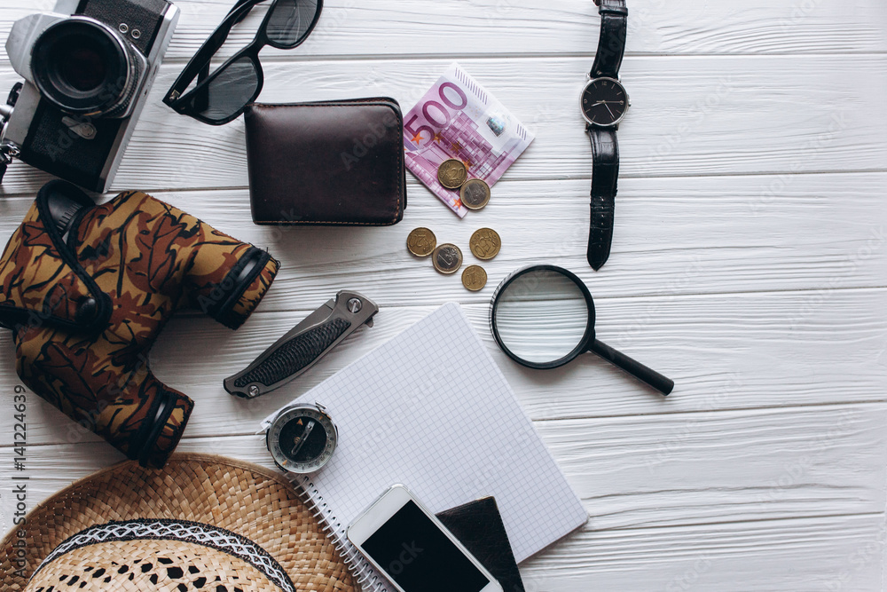 Travel concept, documents, hat, compass, money, phone and camera on a white background Travel concept, documents, hat, compass, money, phone and camera on a white background