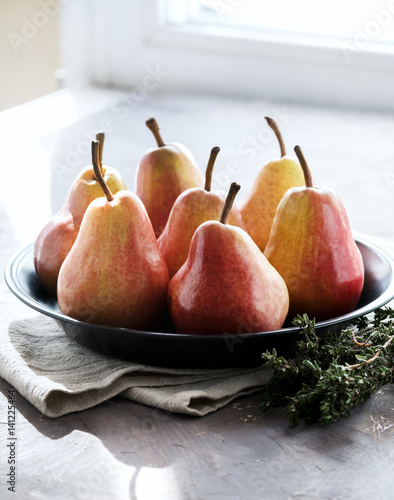 Fresh ripe pears on a plate Vertical photo photo