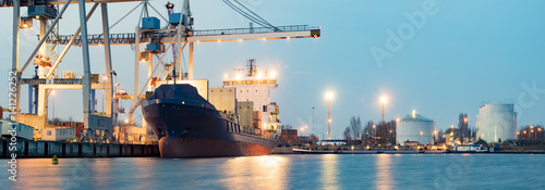 Containers loading by crane in the morning , Trade Port , Shipping