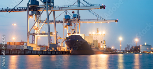 Containers loading by crane in the morning , Trade Port , Shipping