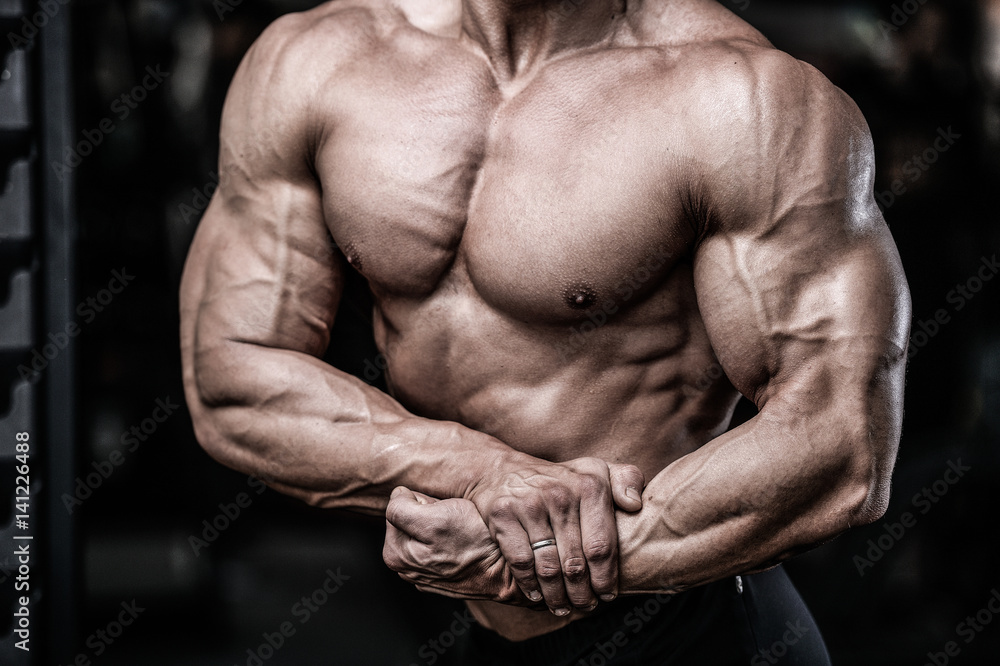 Handsome power athletic man on diet training pumping up muscles Handsome power athletic man on diet training pumping up muscles