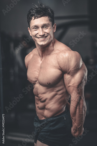 Brutal caucasian handsome fitness men on diet training triceps gym