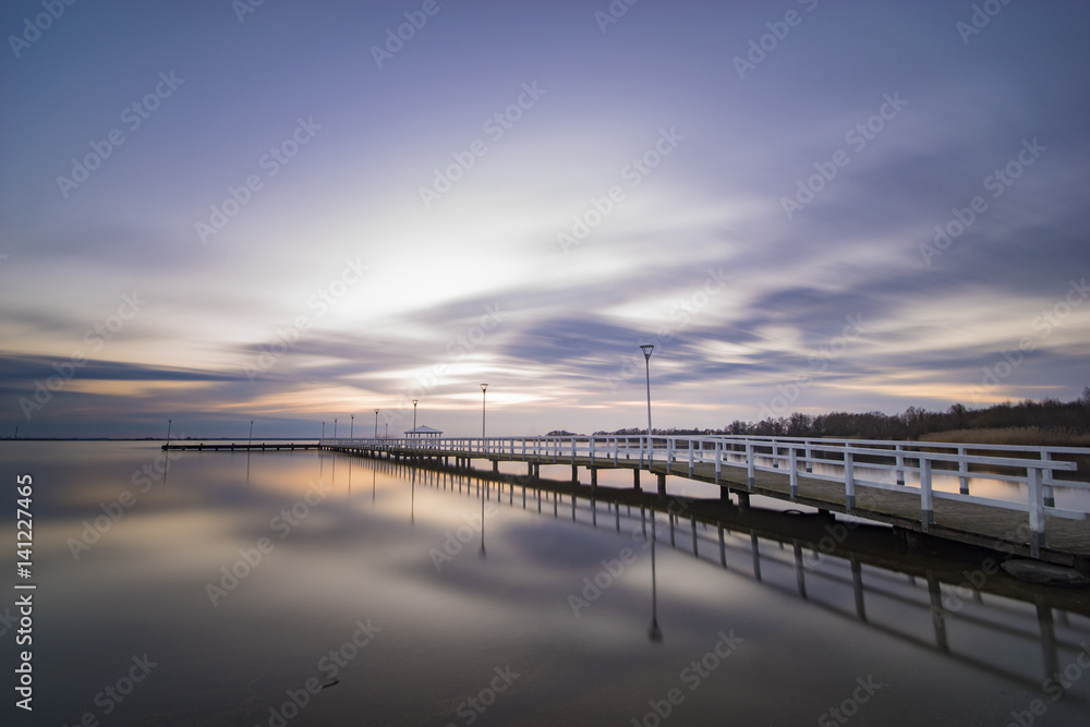 wooden pier by the sea, long exposure, evening