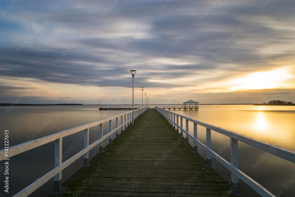 wooden pier by the sea, long exposure, evening