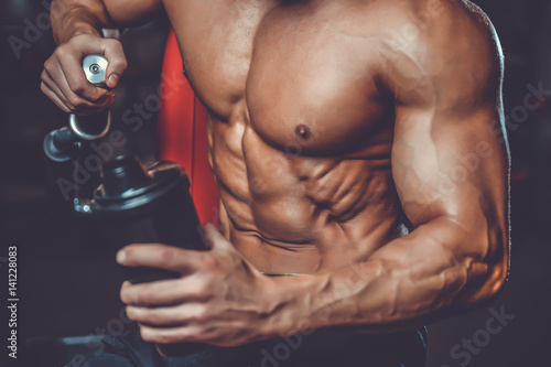 Muscular Man Resting After Exercise And Drinking From Shaker