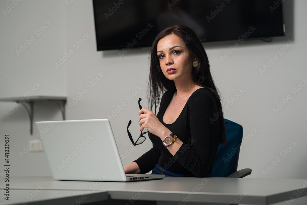 Young business woman at her office working cassualy Young business woman at her office working cassualy