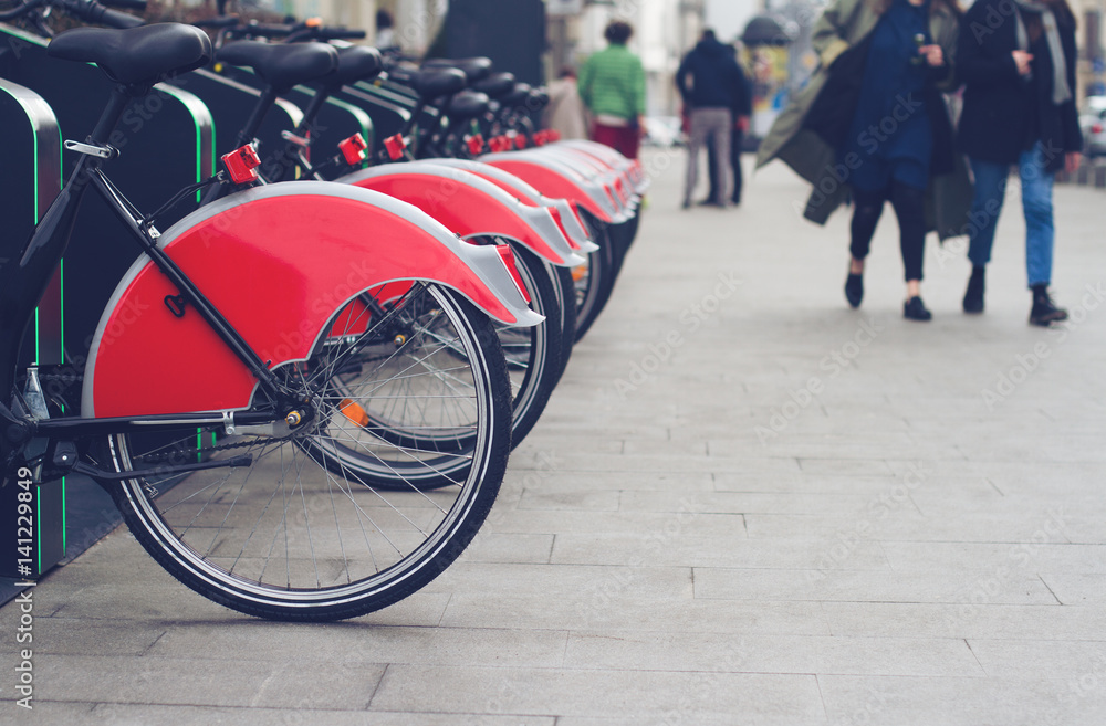 city bike stand with red bicycles
