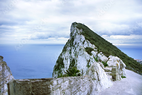 A view of Rock of Gibraltar from an observation desk, Mediterranean sea and a road on cloudy day.