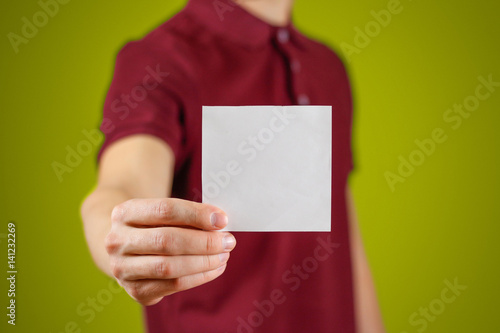 Man showing blank white square flyer brochure booklet. Leaflet presentation. Pamphlet hold hands. Man show clear offset paper. Sheet template. Booklet design sheet display read first person