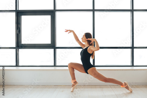 Beautiful young athletic woman dancer at a training session. Ballerina. Preparing for the competition. Classes in single sports.