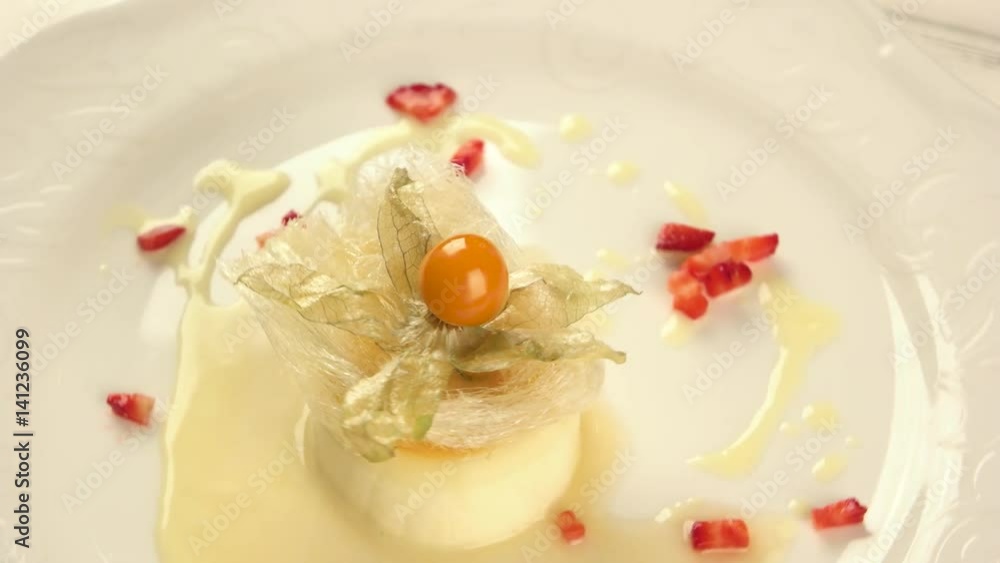 Decorated creme caramel pudding. Spun sugar and physalis flower. Decorated creme caramel pudding. Spun sugar and physalis flower.