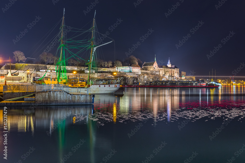 Night view of the Akershus Fortress in Oslo, Norway. View from the Aker Brygge Marina. Oslo, Norway. Night view of the Akershus Fortress in Oslo, Norway. View from the Aker Brygge Marina. Oslo, Norway.