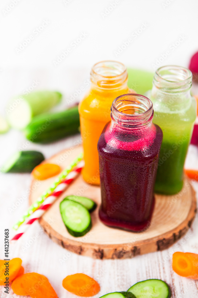 Freshly squeezed vegetable juice in bottles, useful vitamin cocktail, detox diet, selective focus Freshly squeezed vegetable juice in bottles, useful vitamin cocktail, detox diet, selective focus