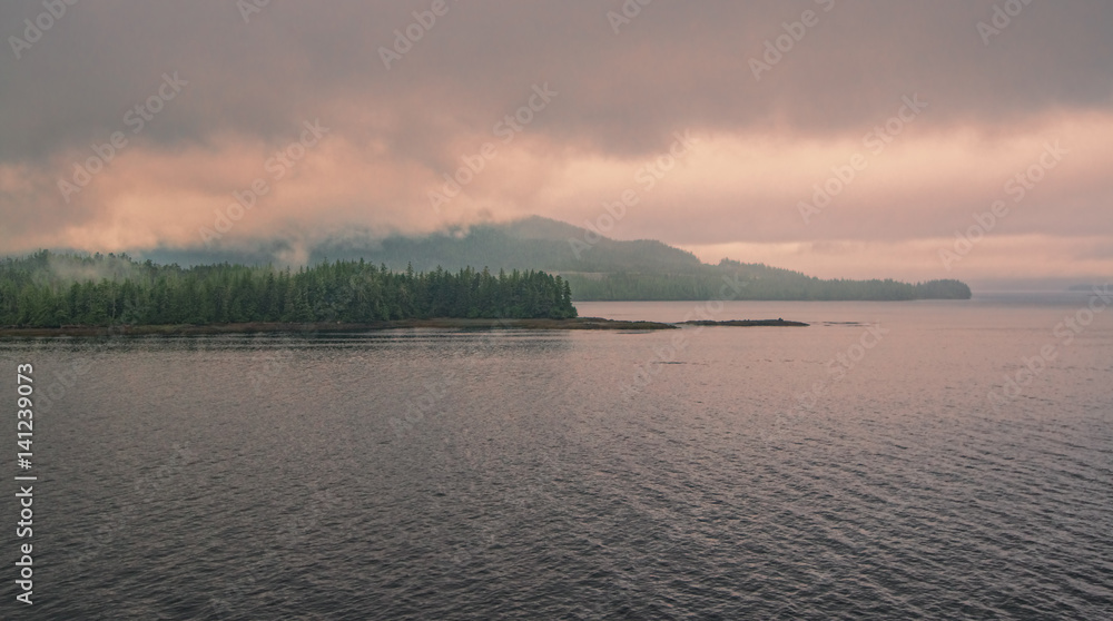 Sunrise in Ketchikan Gateway fjord with storm clouds