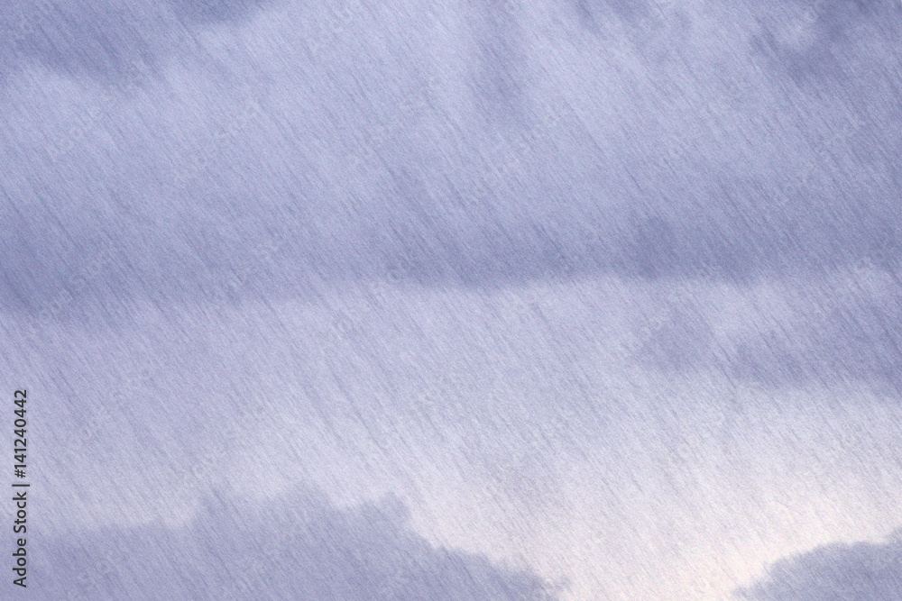 The texture of a strong inclined rain against a background of dark gray continuous clouds. The texture of a strong inclined rain against a background of dark gray continuous clouds.