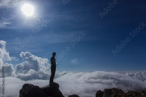 A mountain tourist looks admiring the nature before his difficult ascent to Mount Elbrus