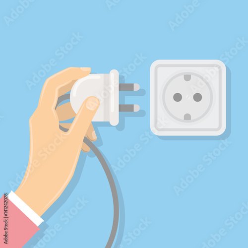 Power plug with socket. Hand holds the plug. Electricity.