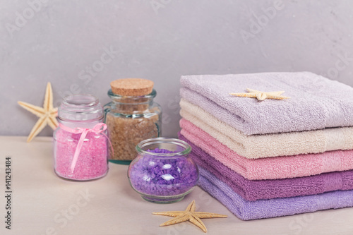 Stack of colorful bath towels on light background.