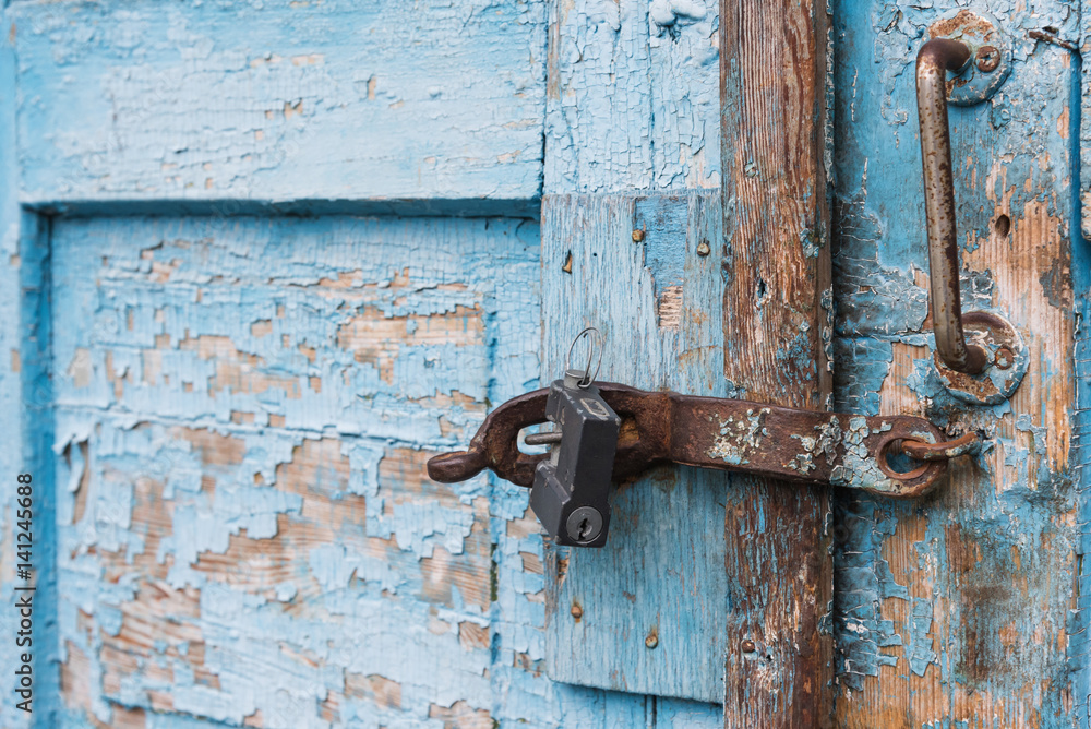 The old door locked with a padlock hanging brackets. Set of backgrounds The old door locked with a padlock hanging brackets. Set of backgrounds