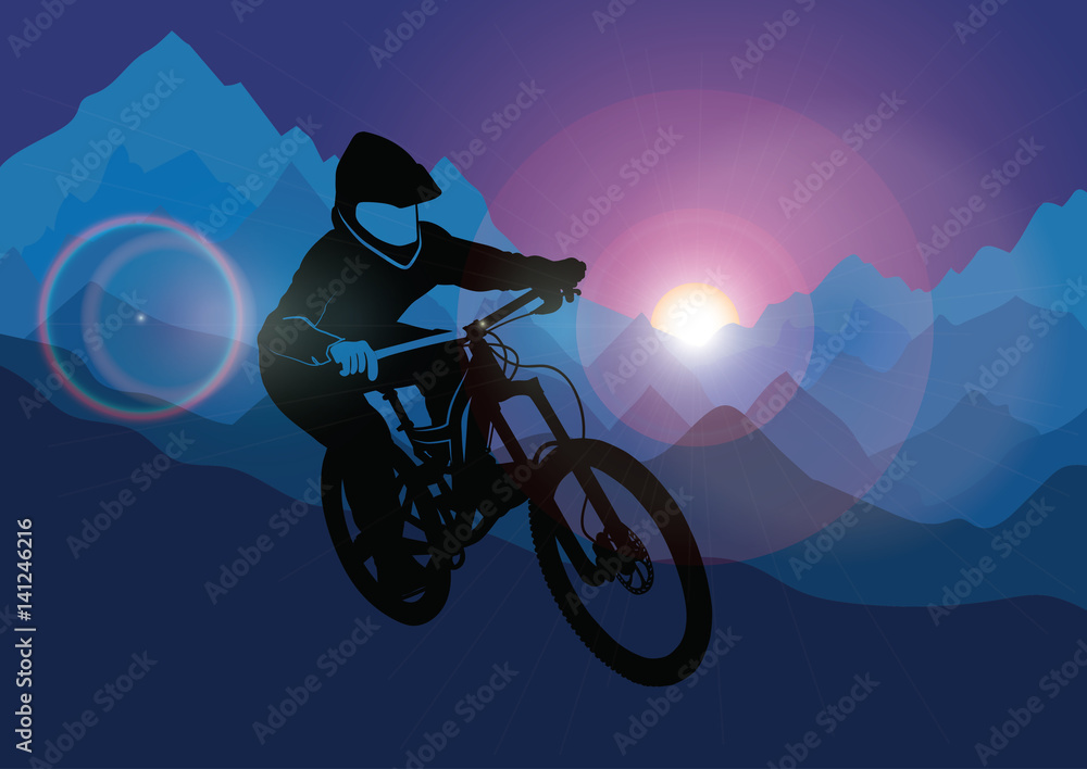 Naklejka premium Silhouette of a racer descending on a bicycle on a mountainside against the background of the evening sun