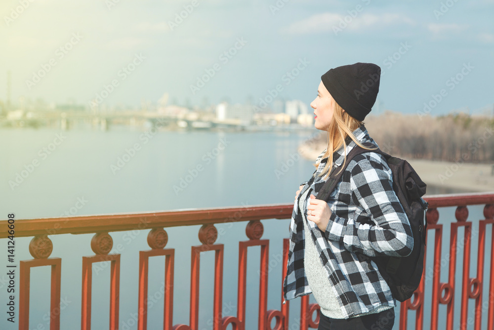 Cheerful woman standing on a bridge