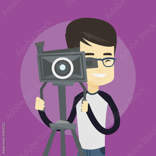 Cameraman with movie camera on tripod.